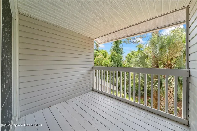 a view of a balcony with wooden floor