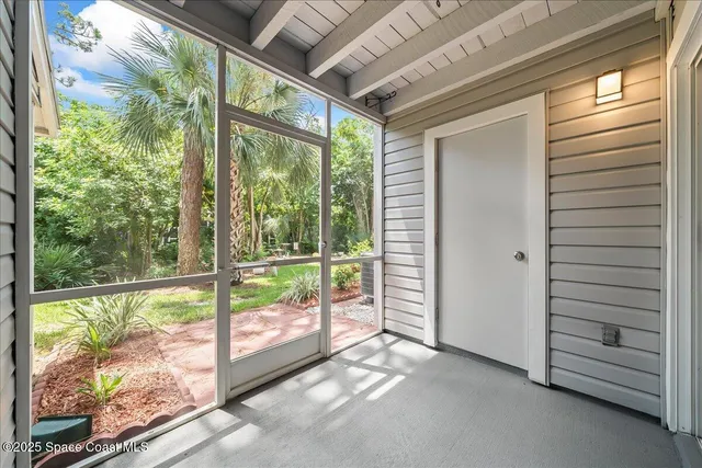 a view of a porch with wooden floor and outside view
