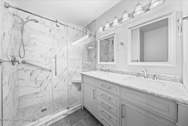 a spacious bathroom with a granite countertop sink a mirror a shower and a shower