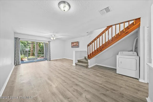 a view of entryway and hall with wooden floor