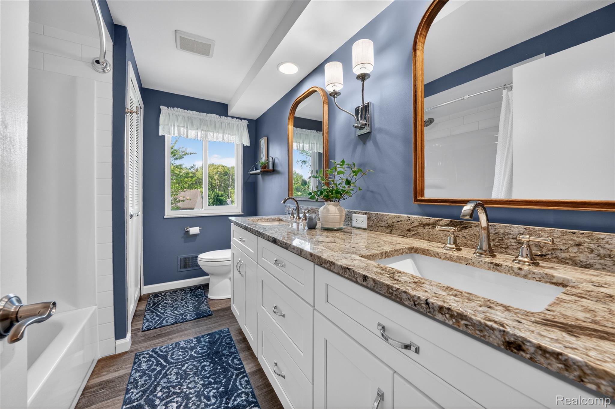 7841 Rampart Trail Waterford, MI 48327 - Photo 22 of 27 Bathroom featuring a double vanity with stone countertops, undermount sinks, and brushed nickel fixtures