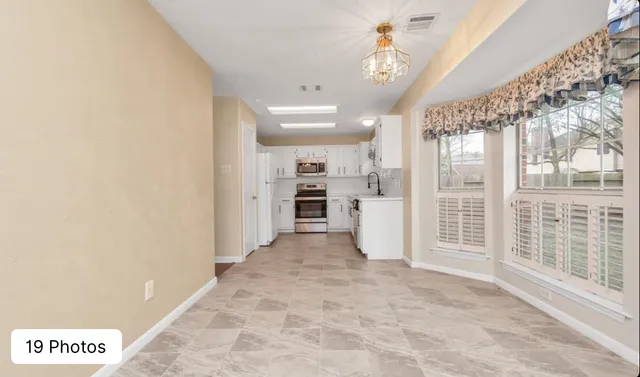 a view of a big room with windows and entryway