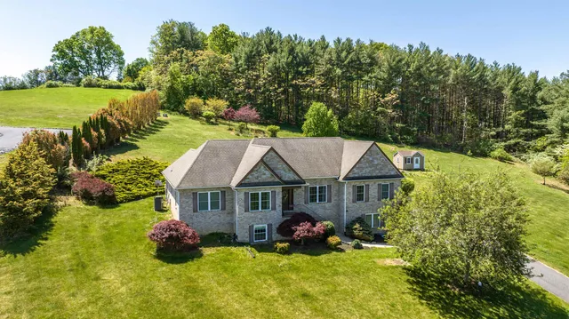 a view of a house with garden and sitting area