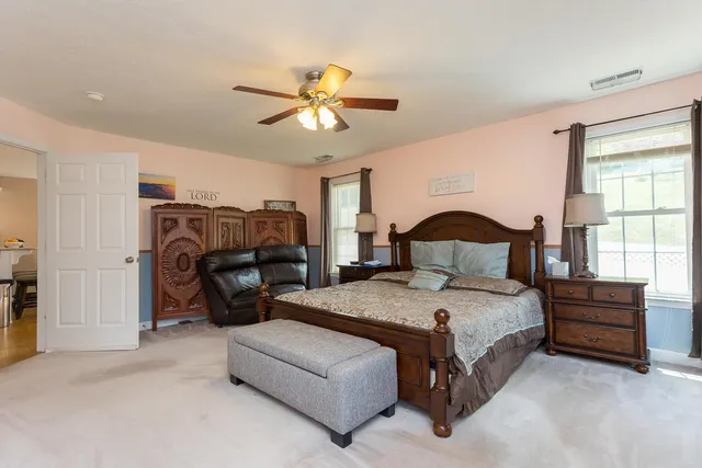 a spacious bathroom with a granite countertop sink and a mirror