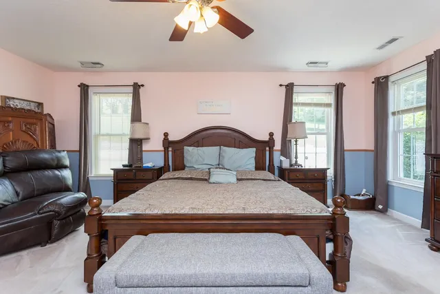 a bathroom with a sink mirror and a toilet