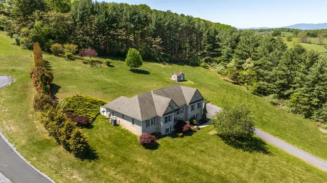 a aerial view of a house with a yard basket ball court and outdoor seating