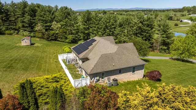 an aerial view of a house with a yard patio and swimming pool