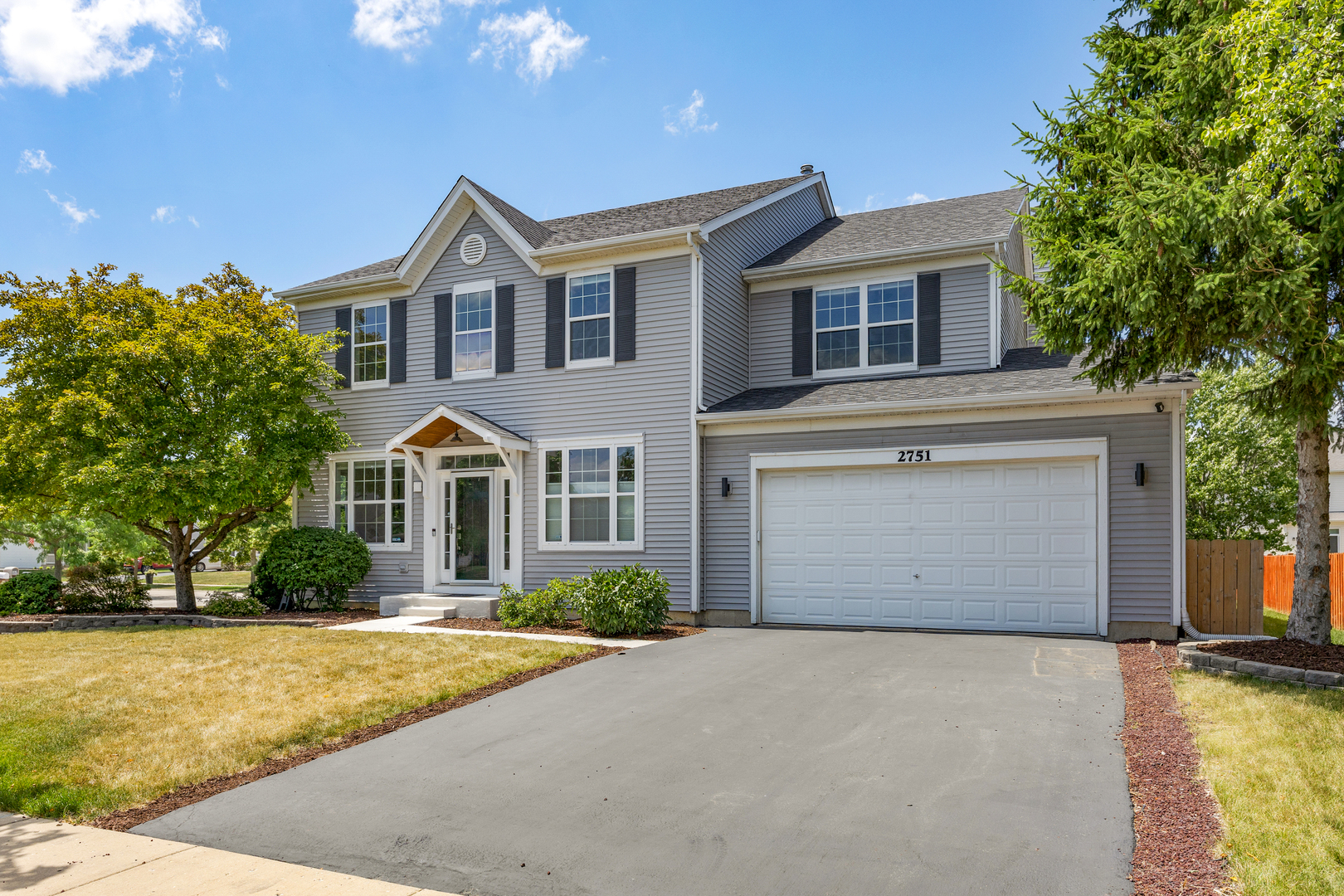 2751 Cedar Creek Cutoff Road Wauconda, IL 60084 - Photo 1 of 34 a front view of a house with a yard and garage