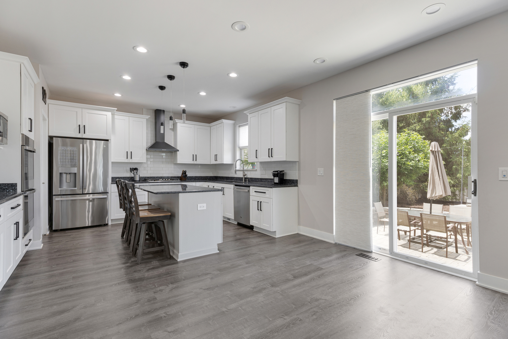 2751 Cedar Creek Cutoff Road Wauconda, IL 60084 - Photo 12 of 34 a kitchen with a table chairs refrigerator and microwave