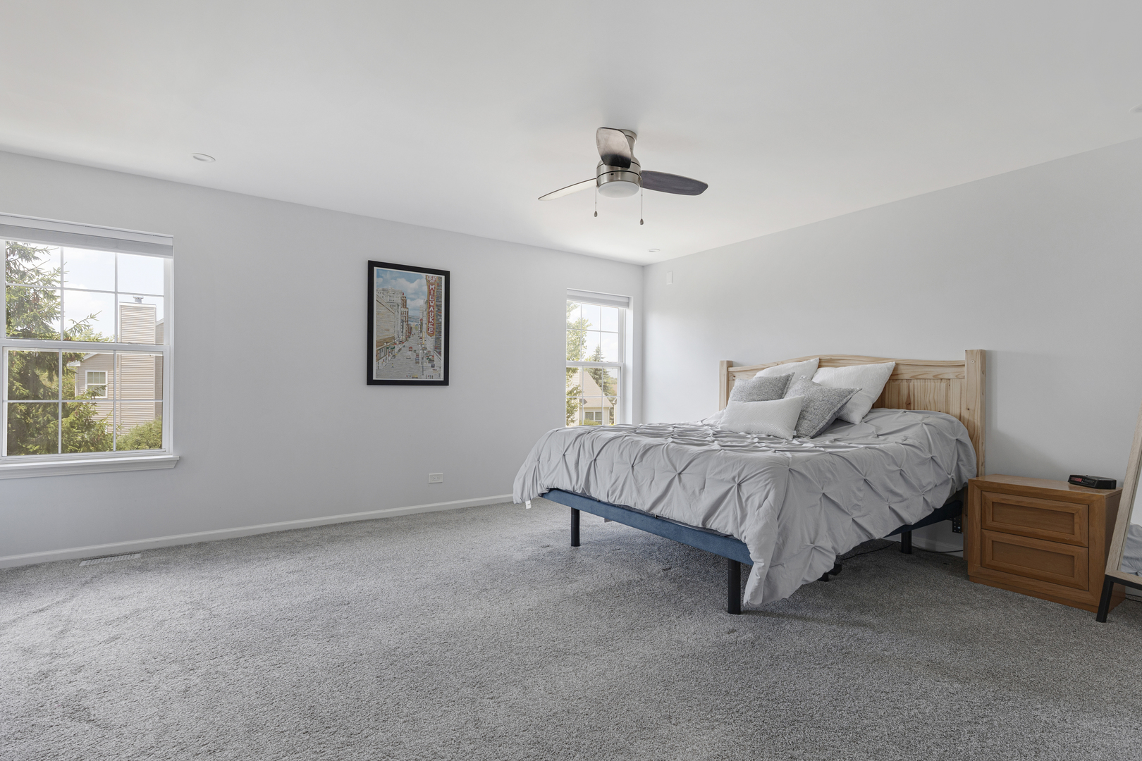 2751 Cedar Creek Cutoff Road Wauconda, IL 60084 - Photo 20 of 34 a spacious bedroom with a bed painting on wall and windows