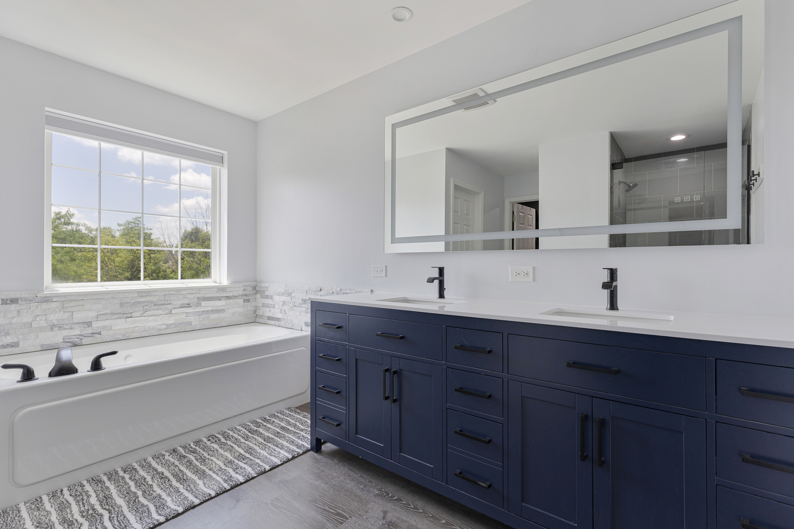 2751 Cedar Creek Cutoff Road Wauconda, IL 60084 - Photo 22 of 34 a bathroom with a tub double sink window and mirror