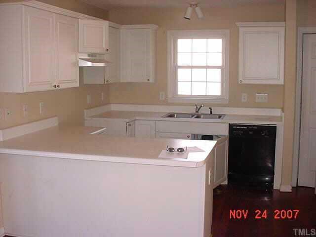 7101 Missionary Ridge Drive Raleigh, NC 27610 - Photo 3 of 4 a kitchen with granite countertop a sink a stove and cabinets