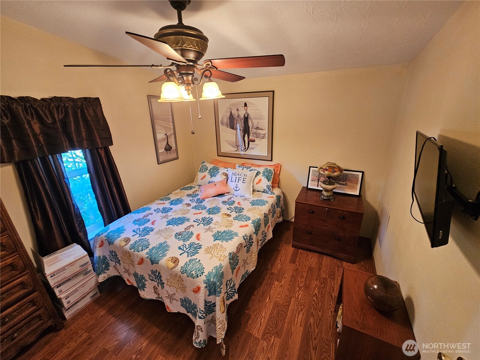 2004 195th Street Long Beach, WA 98631 - Photo 24 of 34 a bedroom with a bed a dresser and flat screen tv