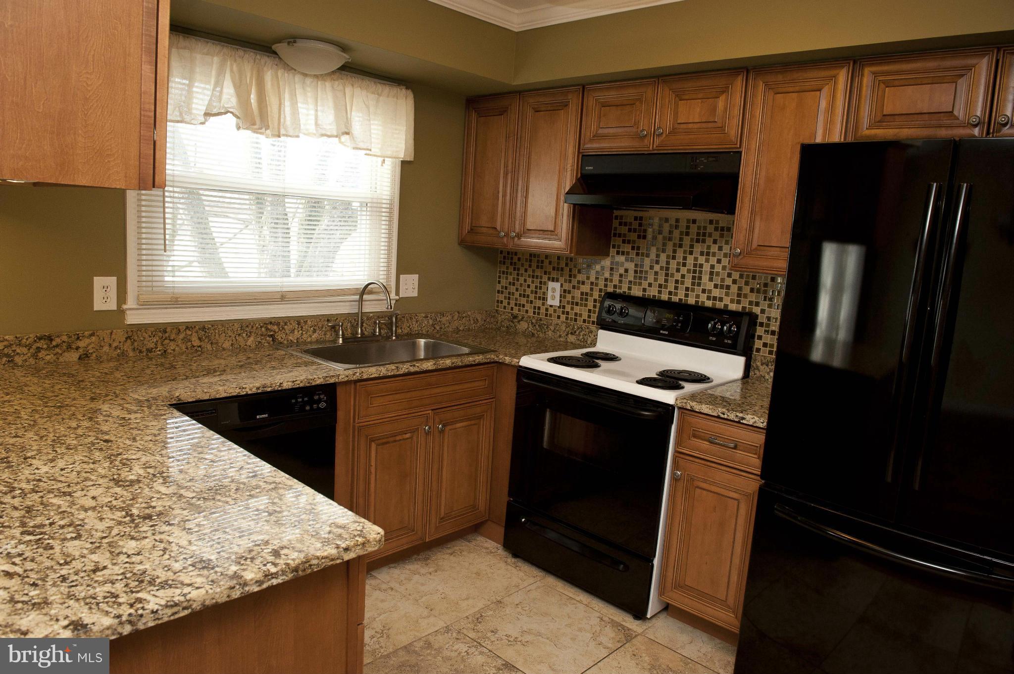 13232 Country Ridge Drive Germantown, MD 20874 - Photo 1 of 30 a kitchen with a sink stove and refrigerator