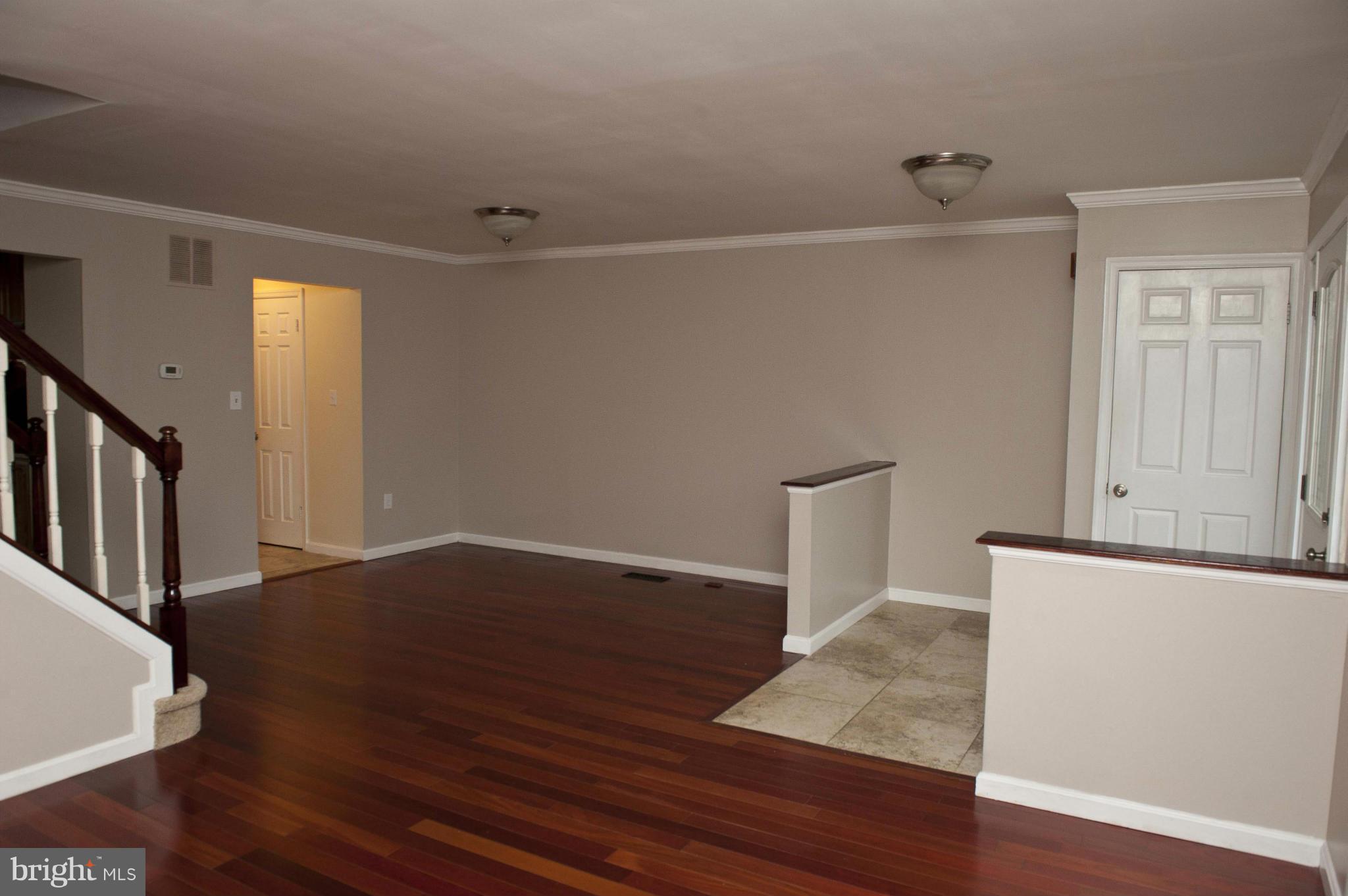 13232 Country Ridge Drive Germantown, MD 20874 - Photo 12 of 30 a view of empty room with wooden floor and fan