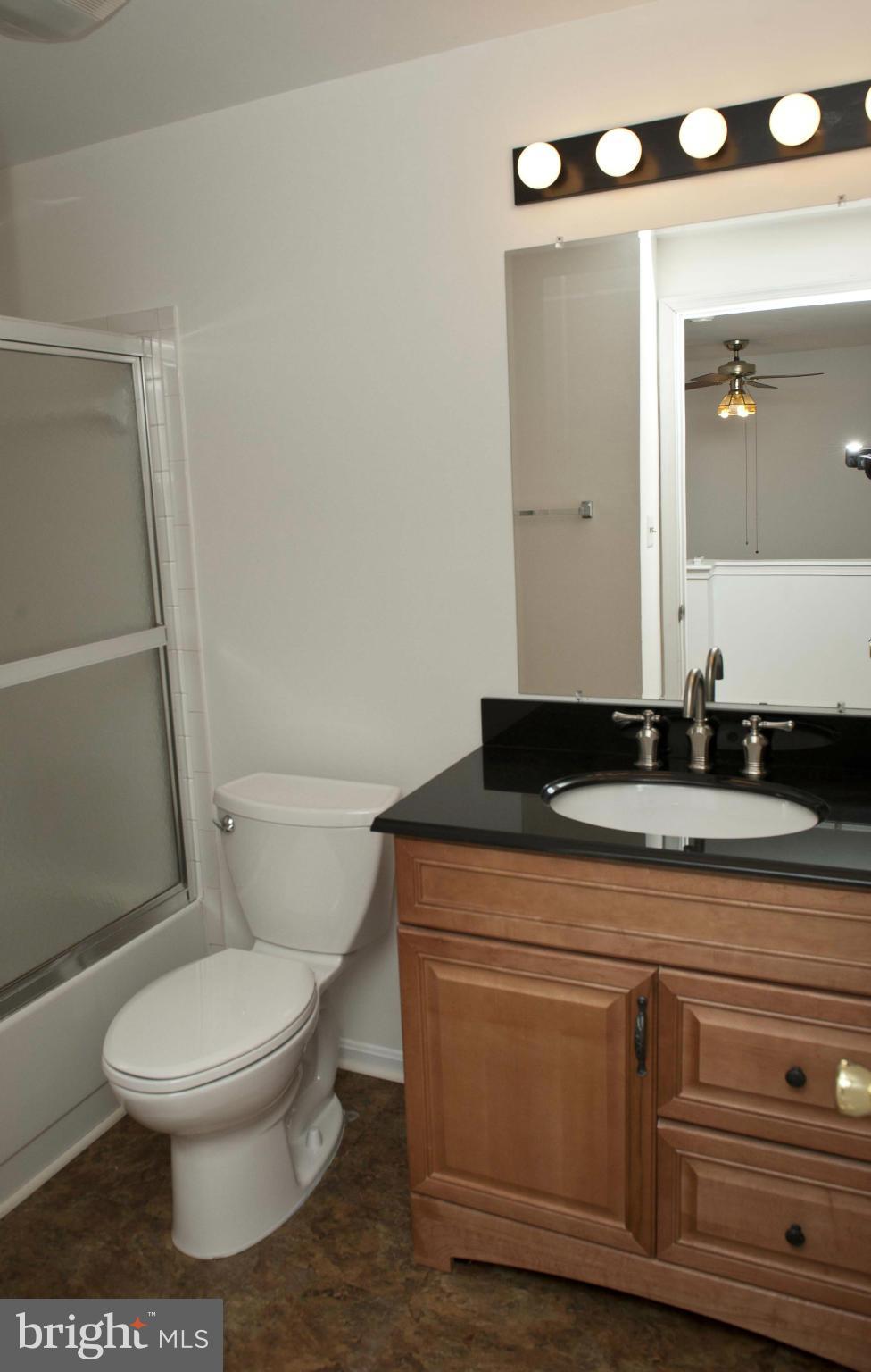 13232 Country Ridge Drive Germantown, MD 20874 - Photo 21 of 30 a bathroom with a granite countertop toilet sink and mirror