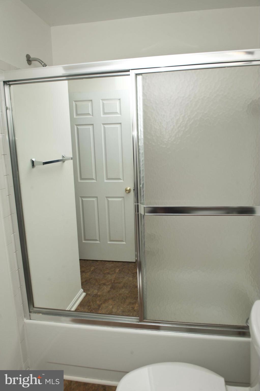 13232 Country Ridge Drive Germantown, MD 20874 - Photo 23 of 30 a bathroom with a glass shower door