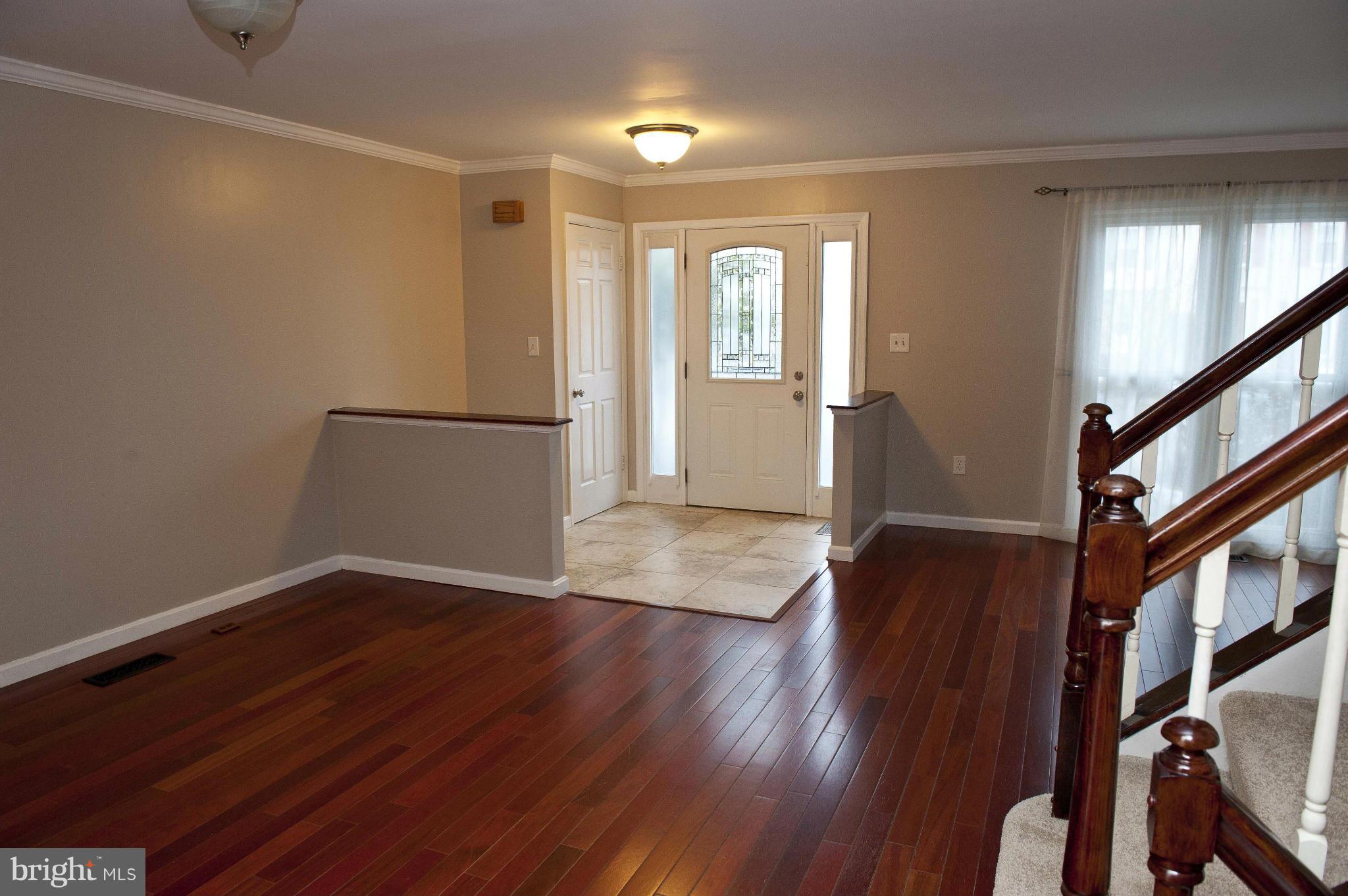 13232 Country Ridge Drive Germantown, MD 20874 - Photo 9 of 30 a view of an empty room with wooden floor and a window