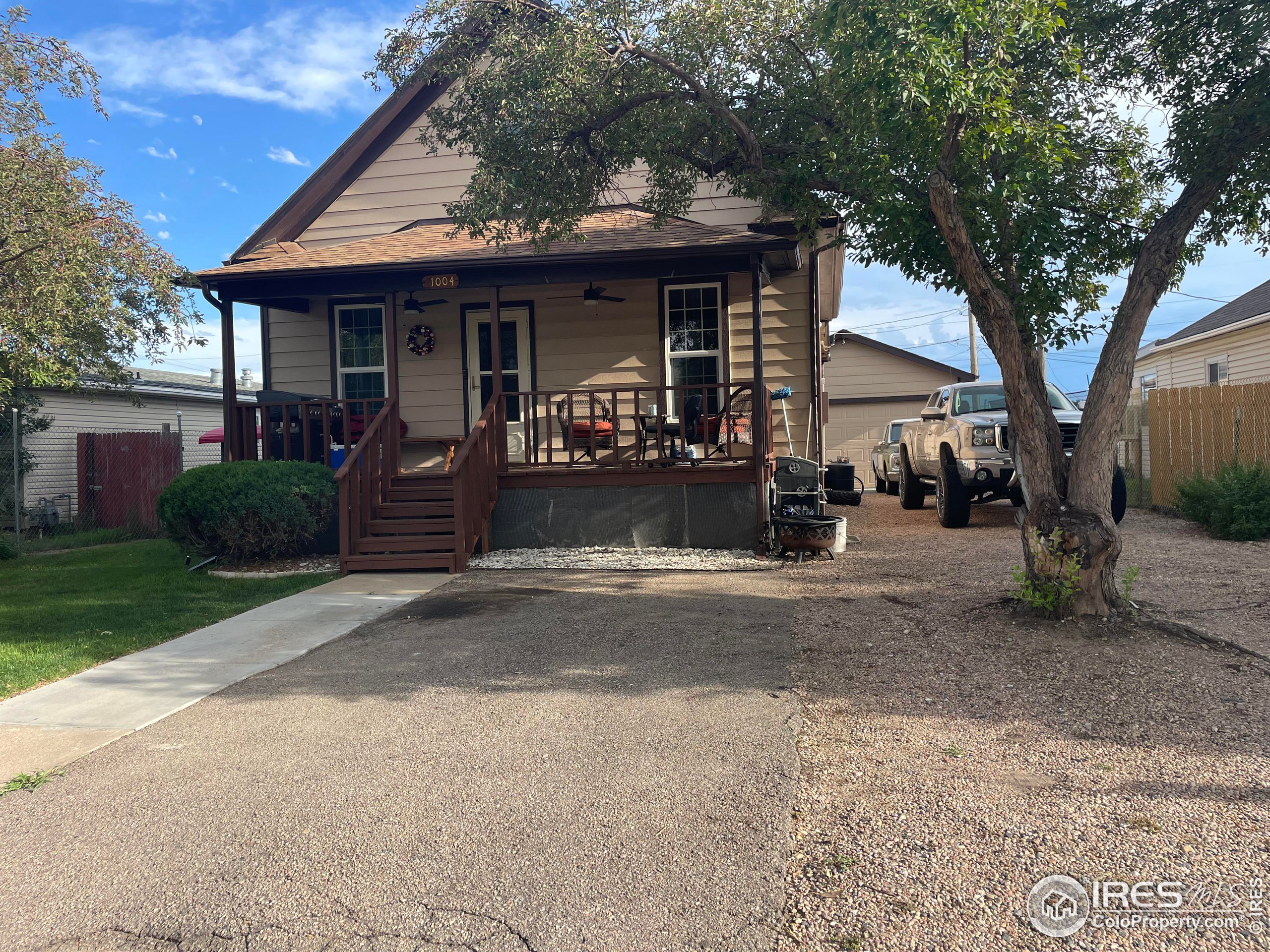 a front view of a house with yard and porch