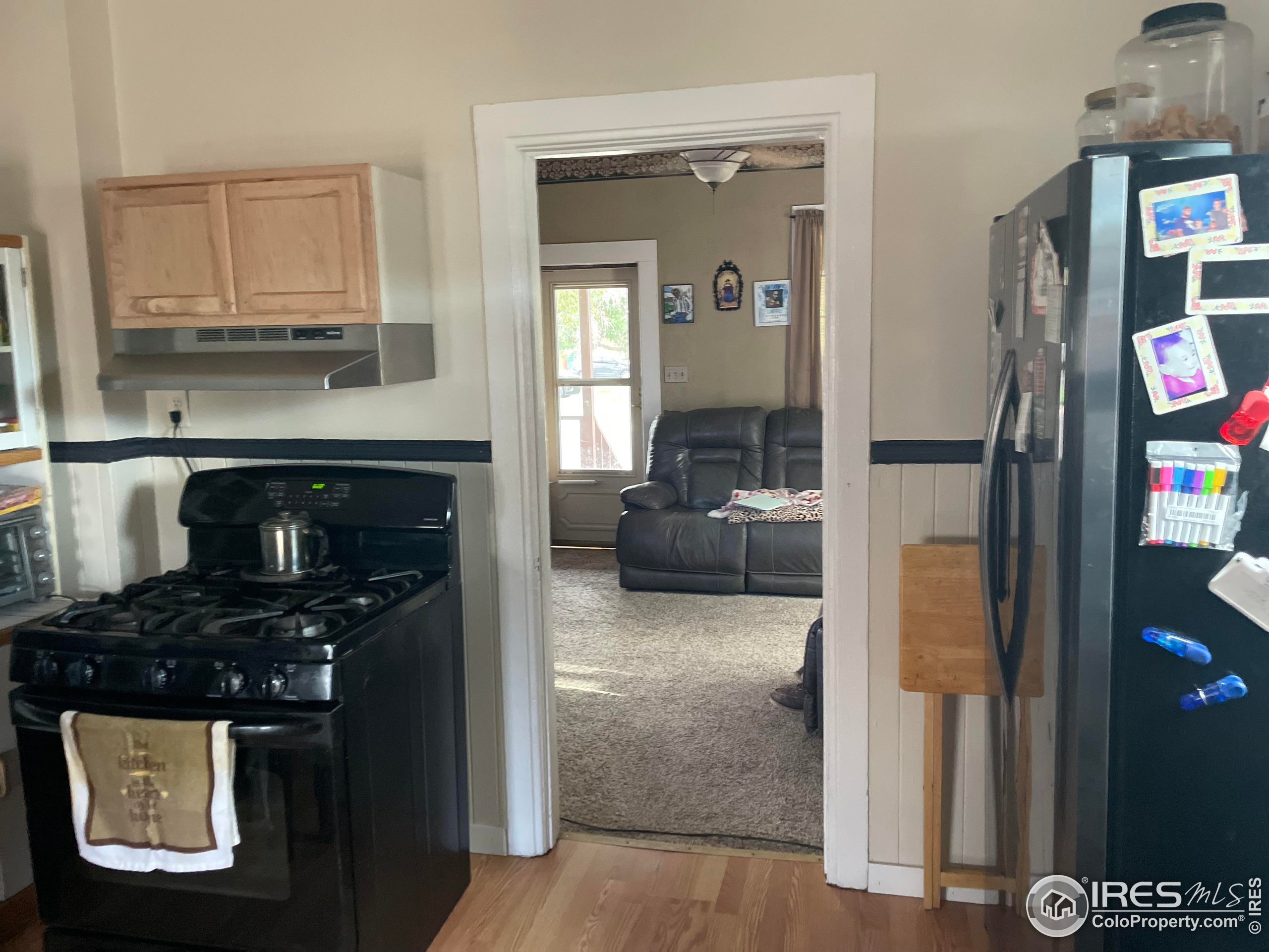1004 1st Street Greeley, CO 80631 - Photo 11 of 27 a kitchen with a refrigerator and a stove