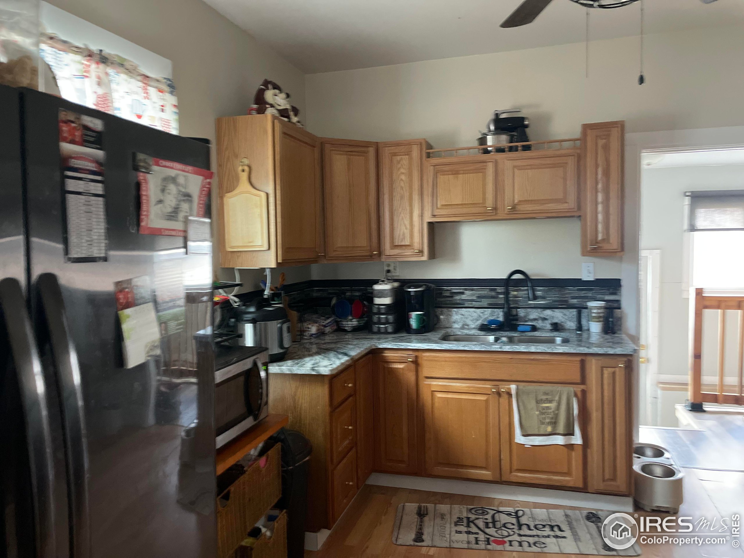 1004 1st Street Greeley, CO 80631 - Photo 12 of 27 a kitchen with a refrigerator a stove a sink dishwasher and cabinets