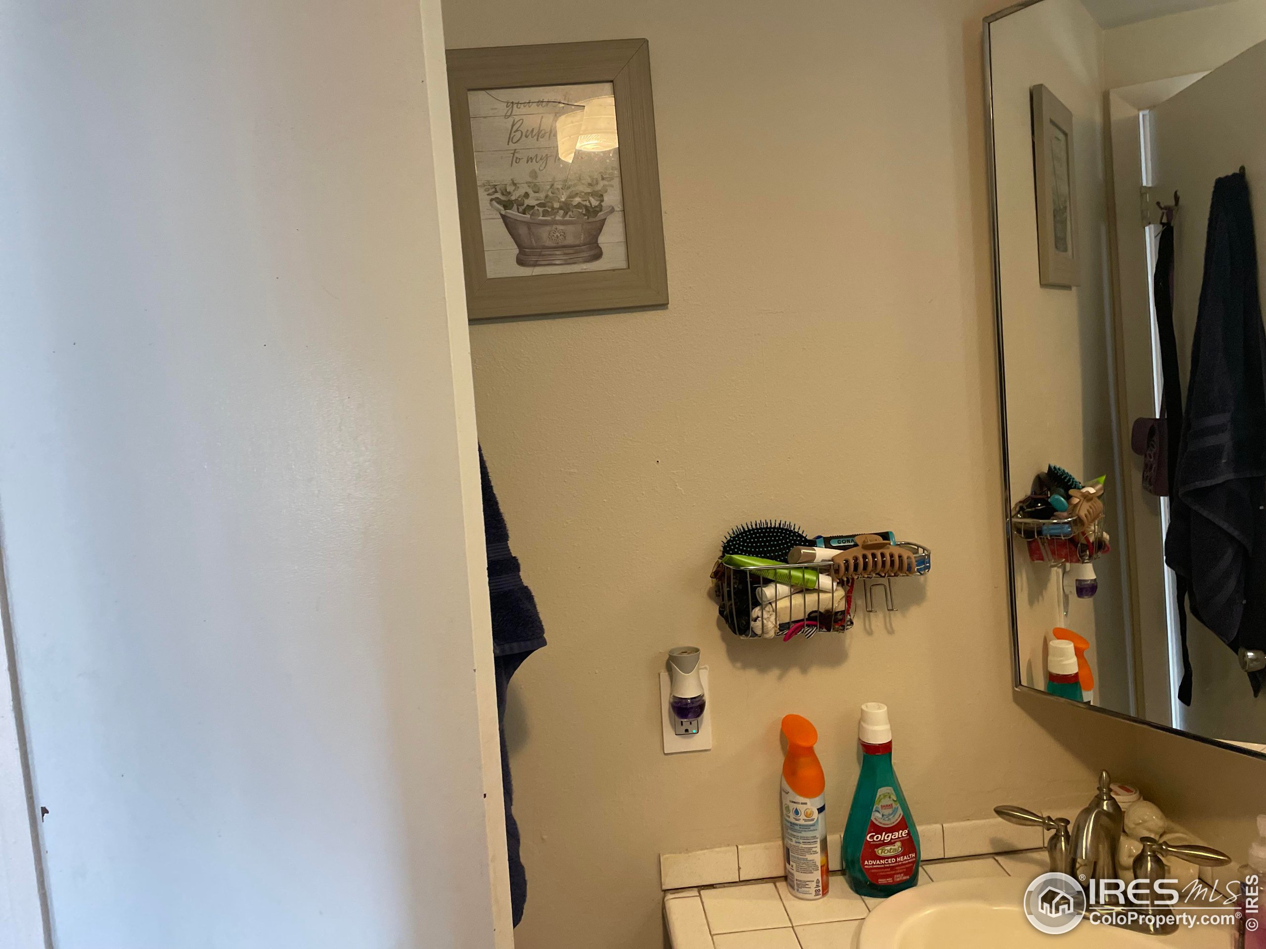 1004 1st Street Greeley, CO 80631 - Photo 14 of 27 a bathroom with a sink and mirror