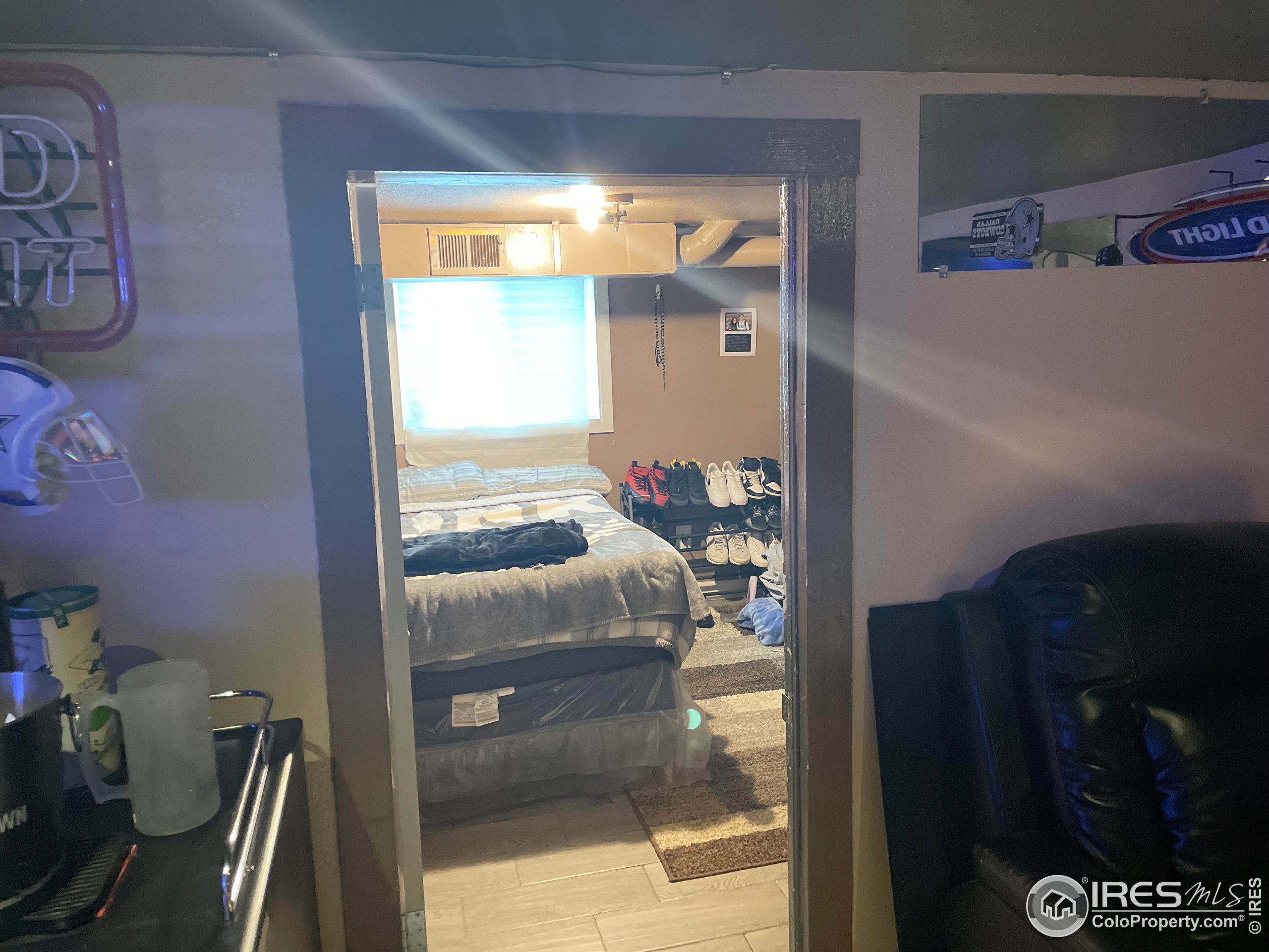1004 1st Street Greeley, CO 80631 - Photo 21 of 27 a bedroom with a bed and a dresser next to a window