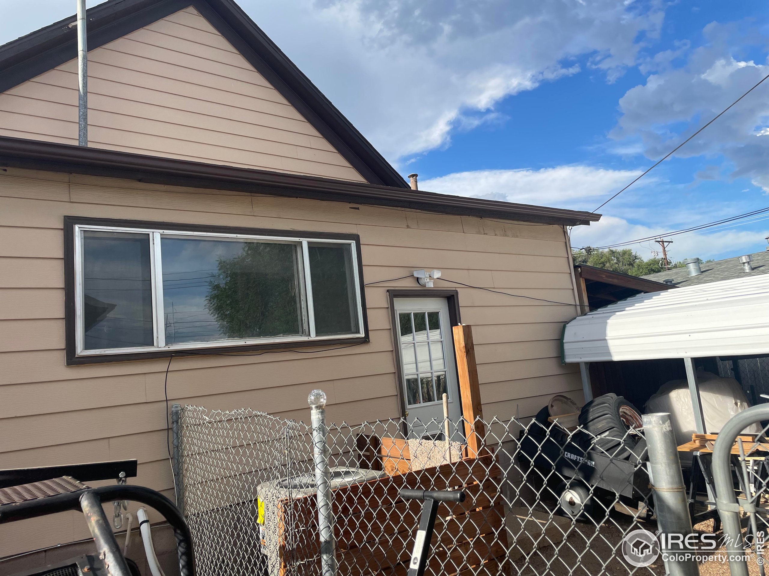 1004 1st Street Greeley, CO 80631 - Photo 4 of 27 a view of a patio with table and chairs with wooden floor and fence