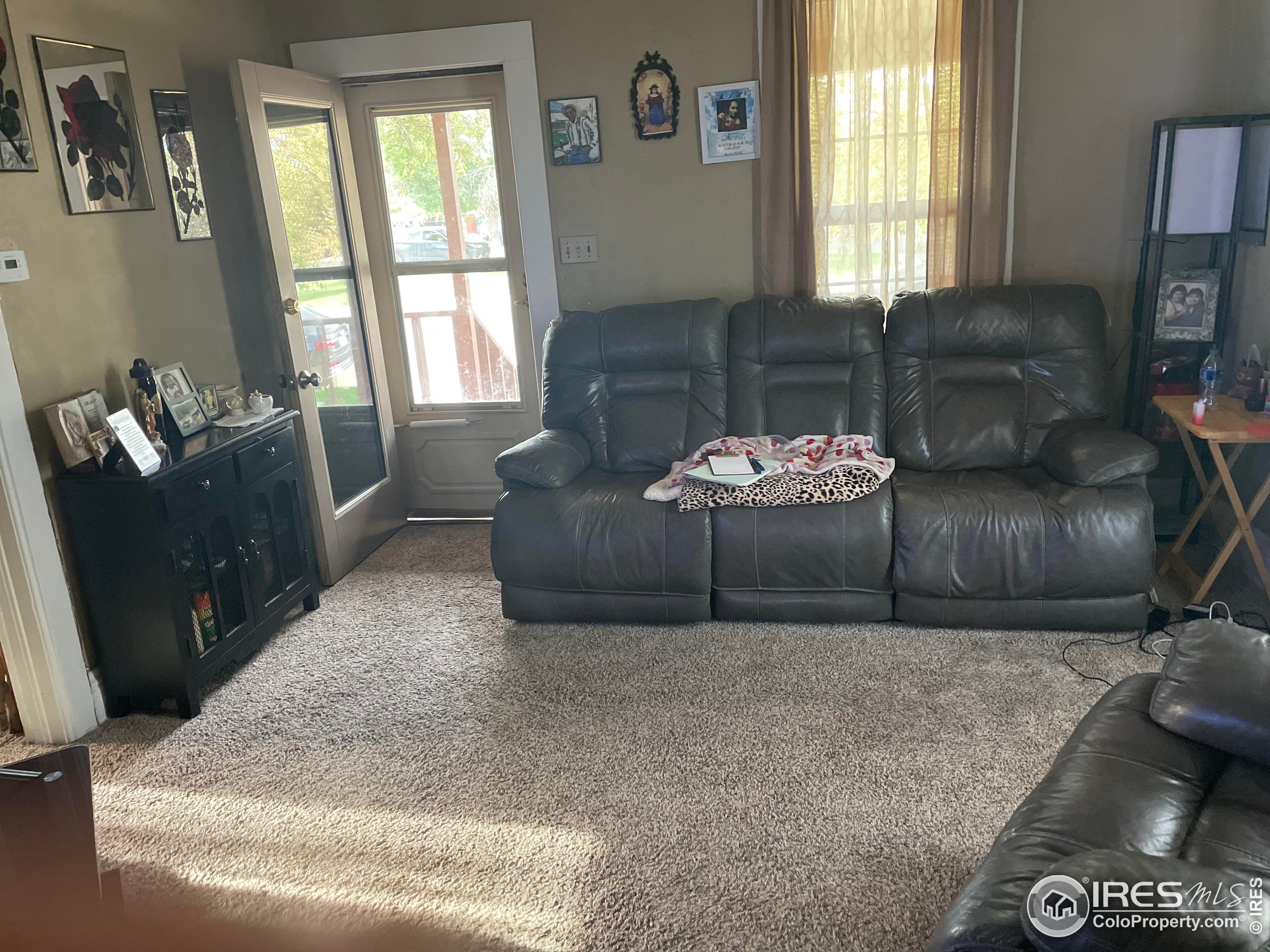 1004 1st Street Greeley, CO 80631 - Photo 8 of 27 a living room with furniture and a window