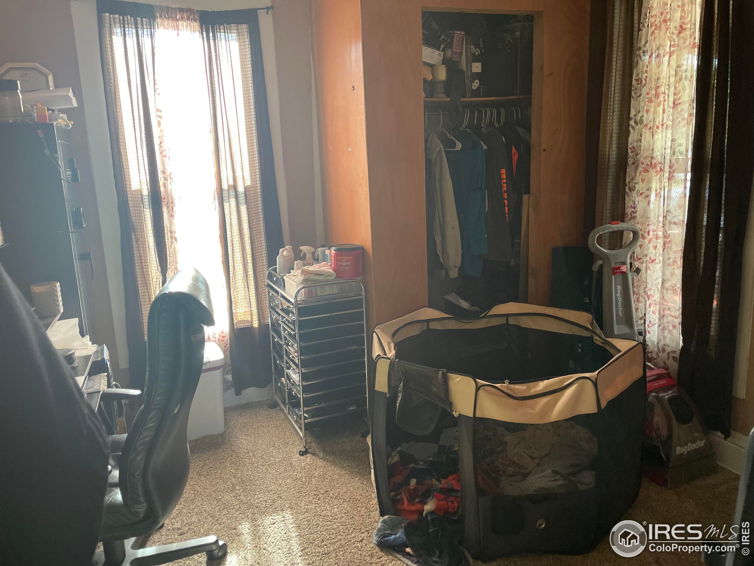 1004 1st Street Greeley, CO 80631 - Photo 10 of 27 a bed sitting in a room next to a window