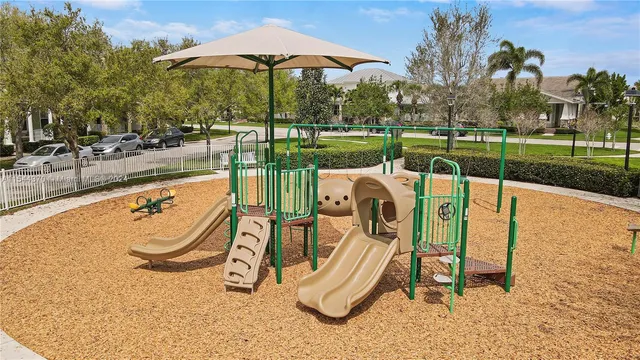a view of a city with lawn chairs and an ocean view