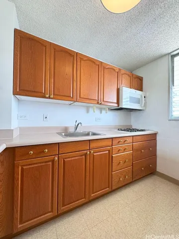 a kitchen with stainless steel appliances granite countertop a sink and cabinets