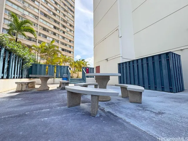 a view of a patio with a table and chairs