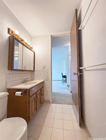 a bathroom with a sink a toilet and mirror