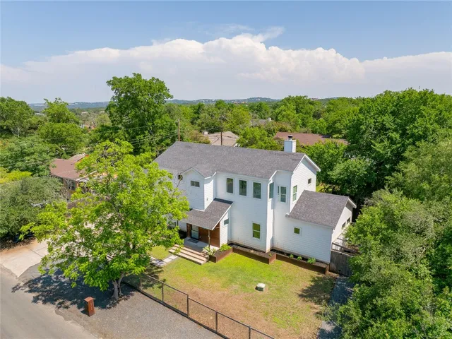 an aerial view of a house with swimming pool and garden