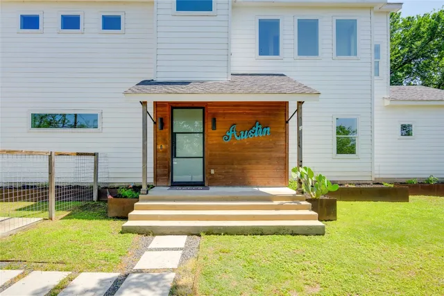 a front view of house with outdoor seating and yard