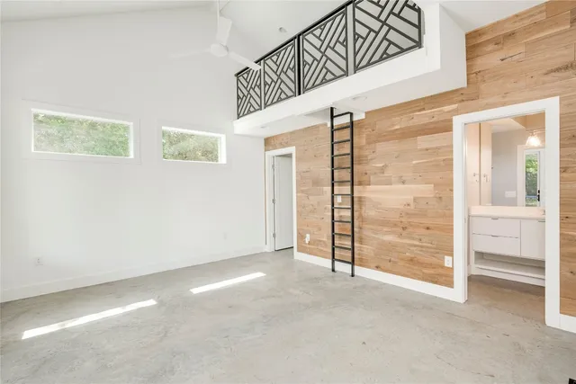 an empty room with cabinet and mirrors