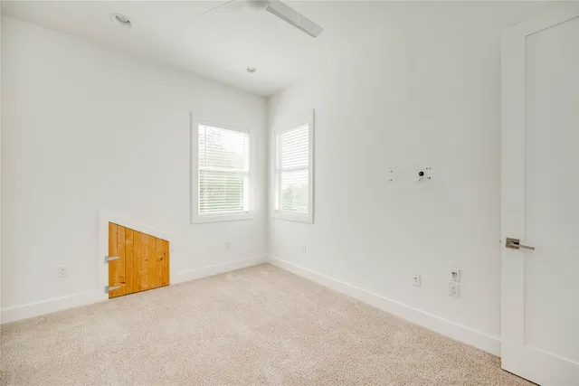 an empty room with kitchen space and window