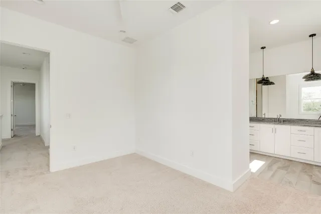 a bathroom with a granite countertop sink a toilet and a shower