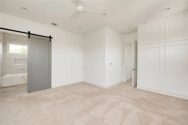 an empty room with a empty space and windows