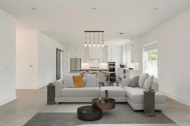 a living room with furniture and a chandelier