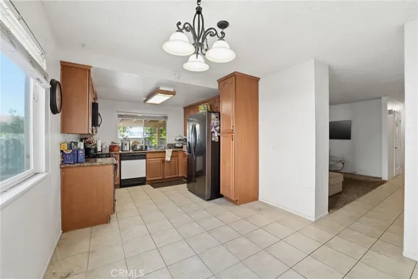 a kitchen with stainless steel appliances granite countertop a stove top oven microwave and refrigerator