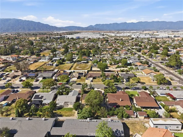 an aerial view of residential house with parking and trees