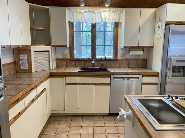 64 James Road Hanover, MA 02339 - Photo 9 of 40 a kitchen with a sink stove and cabinets