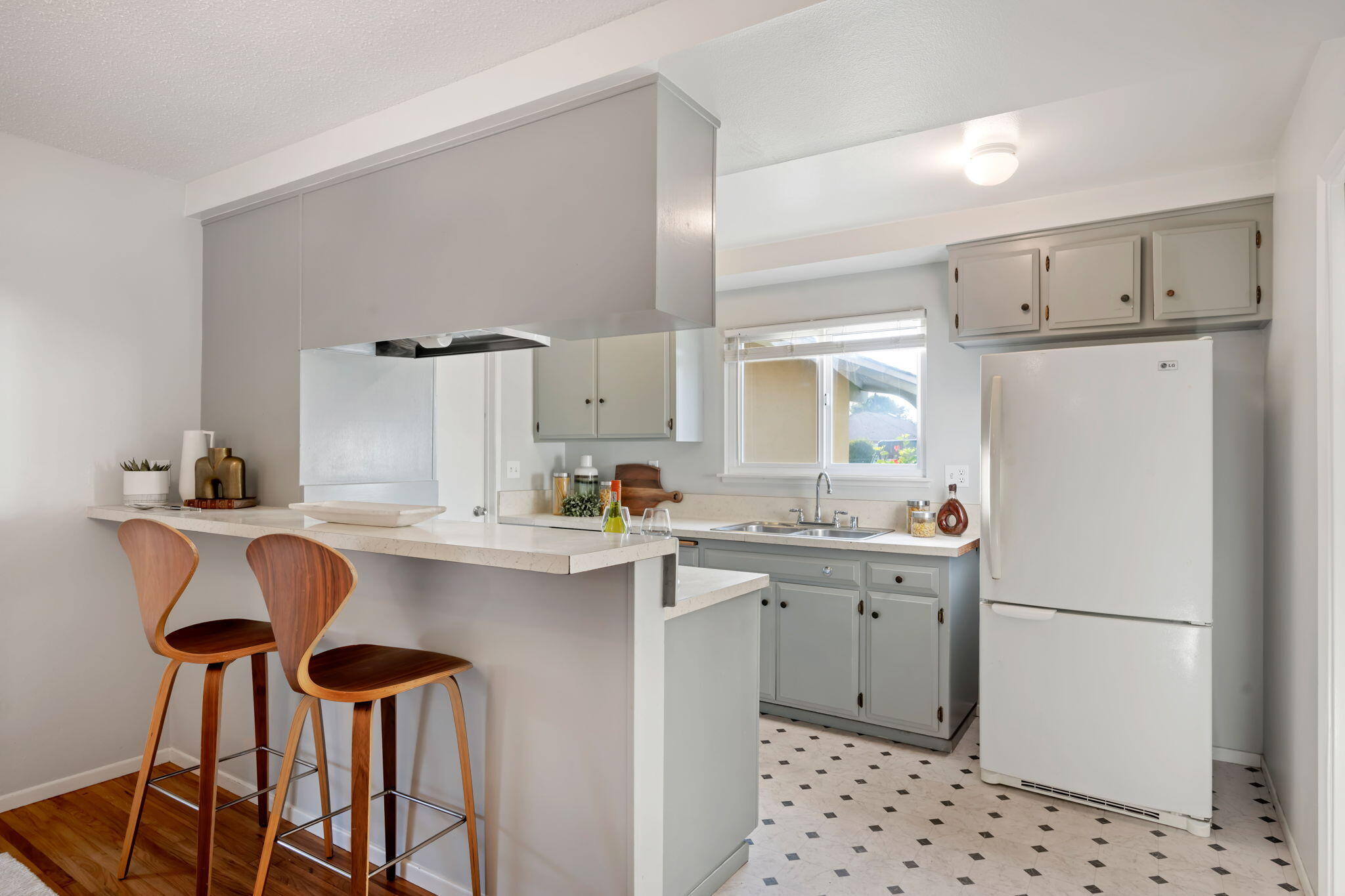 52 Deerhurst Drive Goleta, CA 93117 - Photo 6 of 18 a kitchen with a sink a stove a refrigerator and white cabinets