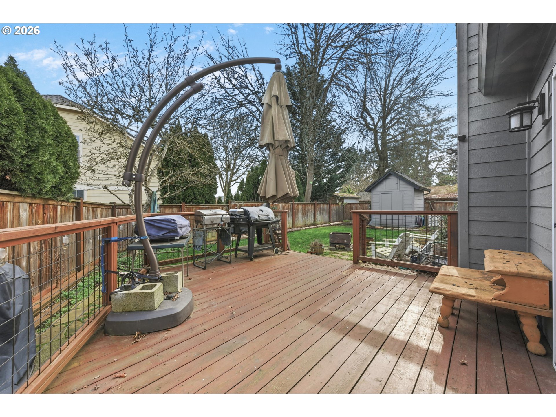 475 Salty Way Eugene, OR 97404 - Photo 44 of 48 a view of a patio with table and chairs a barbeque with wooden floor and fence