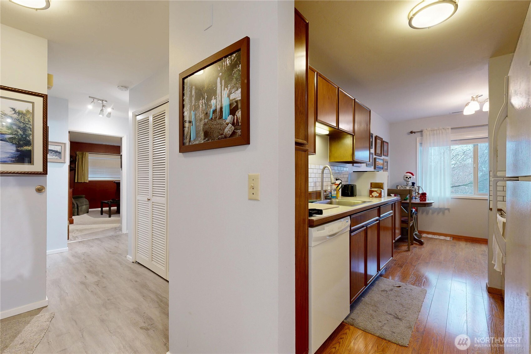 364 Catherine Street, Unit B6 Walla Walla, WA 99362 - Photo 17 of 26 a kitchen with stainless steel appliances granite countertop a refrigerator a stove top oven a sink a dining table and chairs with wooden floor