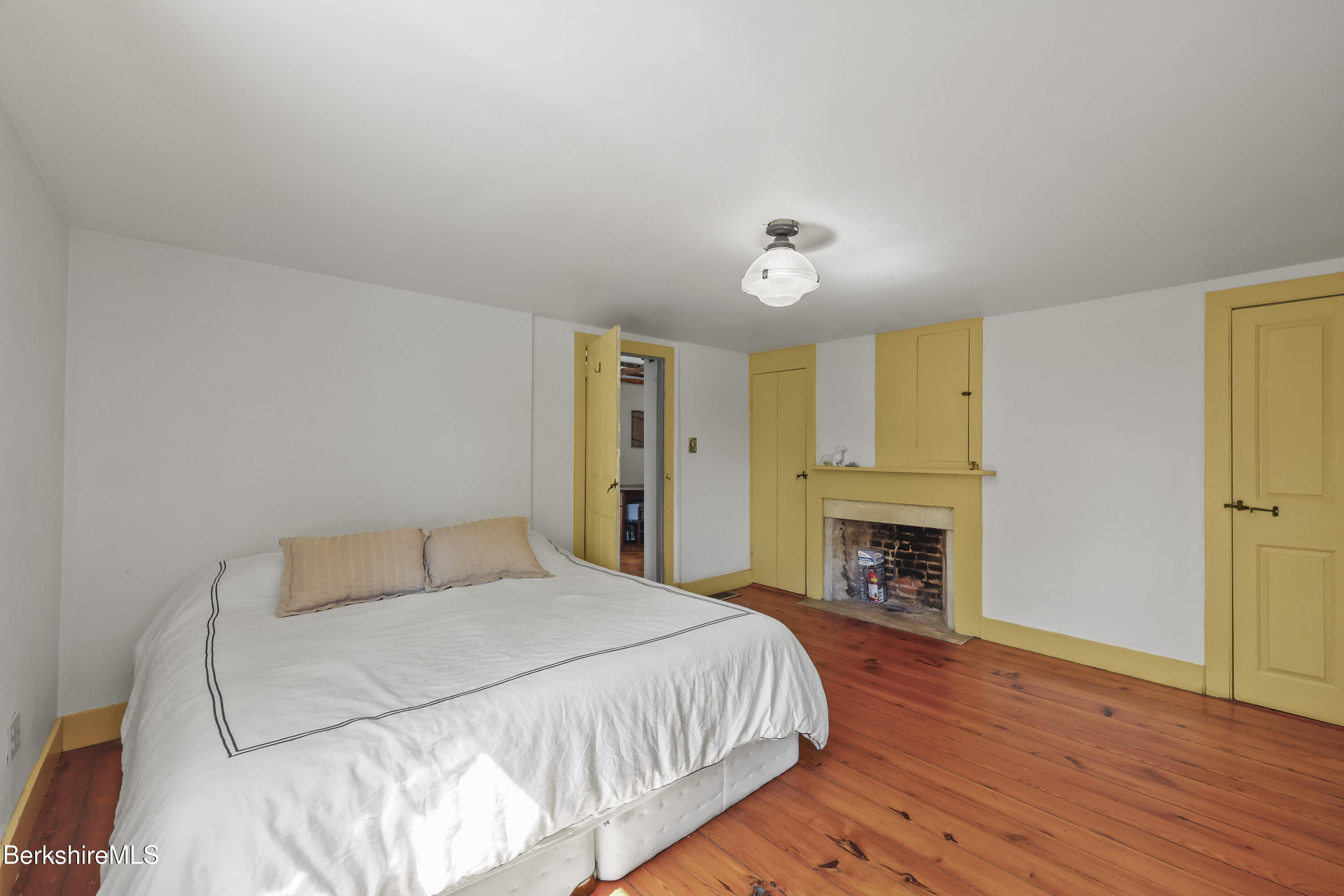 276 Great Barrington Road West Stockbridge, MA 01236 - Photo 29 of 68 a spacious bedroom with a bed and a fireplace