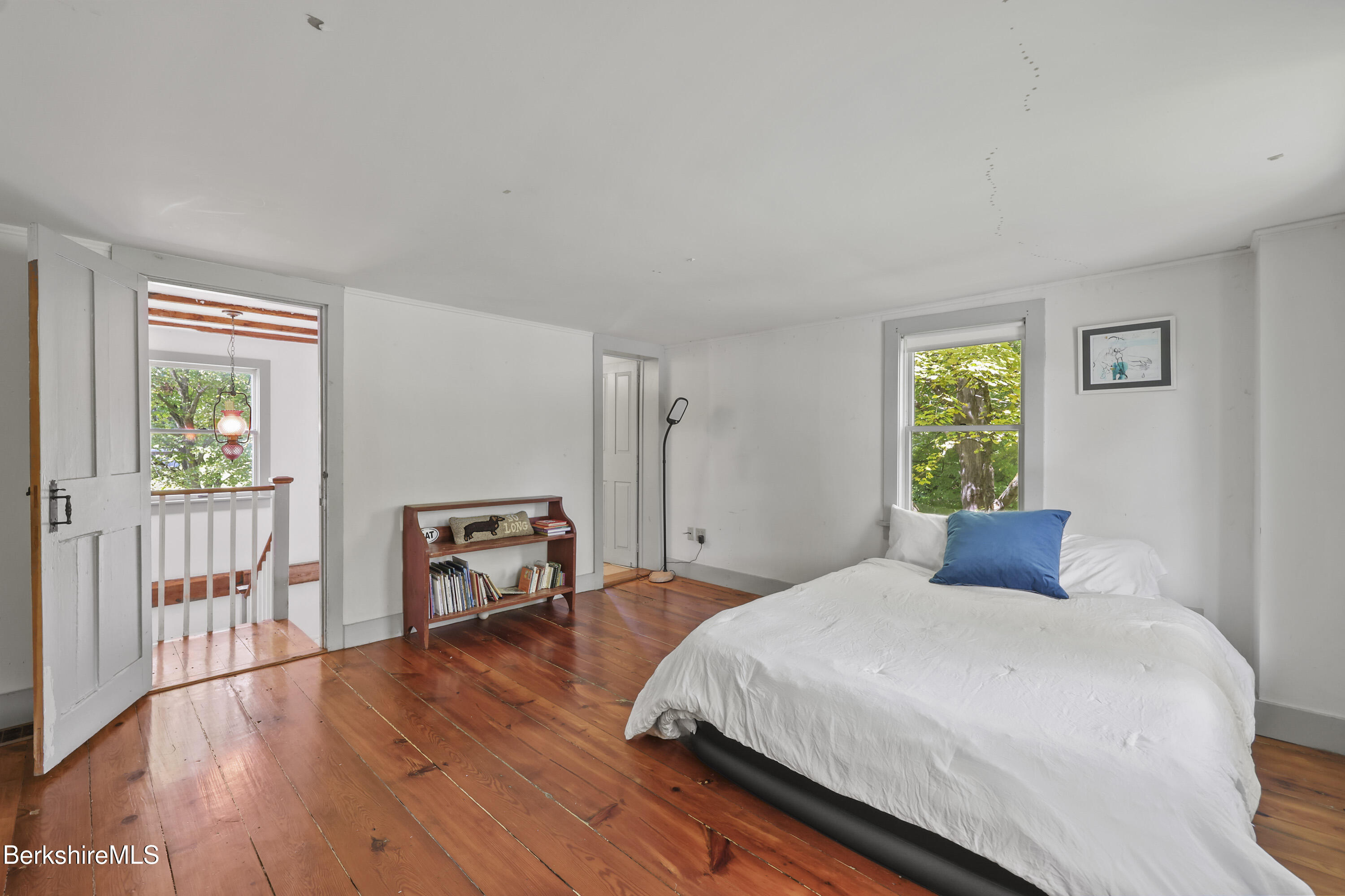 276 Great Barrington Road West Stockbridge, MA 01236 - Photo 32 of 68 a bedroom with a bed and a table next to a window