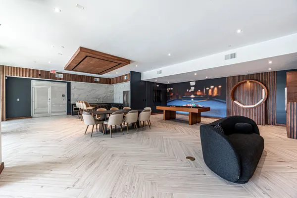 a bedroom with furniture and a mirror